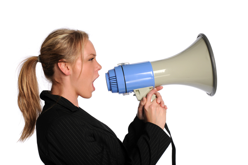 Young Businesswoman Screaming With A Megaphone Isolated On A White Background