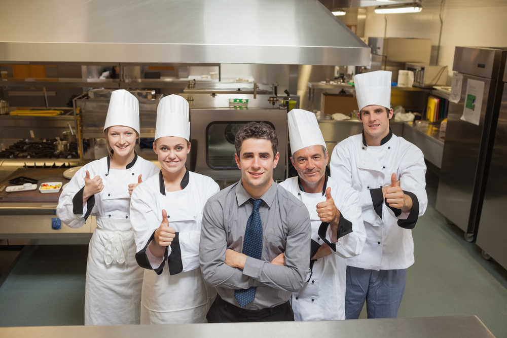 Five Workers In Restauran With Chef's Giving Thumbs Up